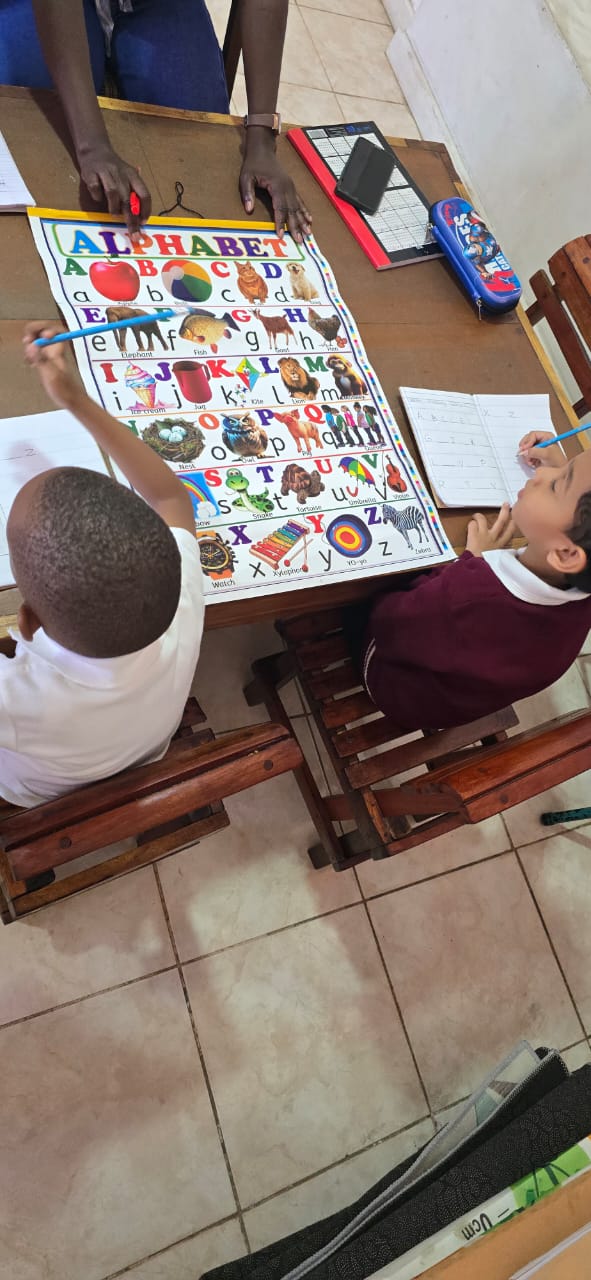 Early Years learners studying the alphabet with their teacher