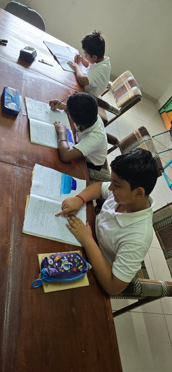 Primary students writing in their exercise books
