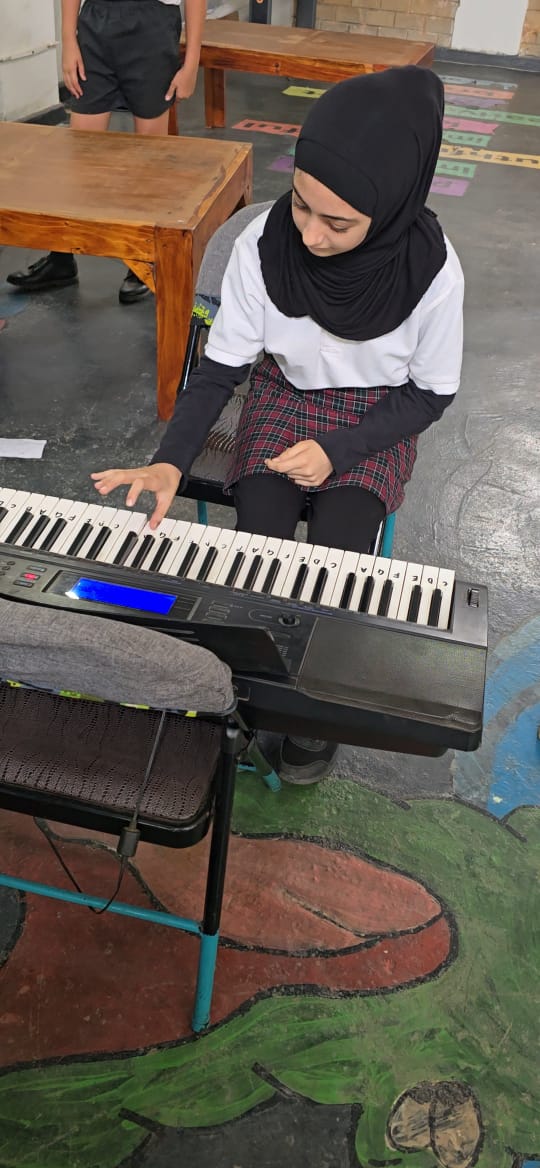 Student playing the keyboard during music class